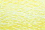 Abstract background composed of overexposed white netting mesh on yellow