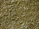 Conceptual background of wrinkled gold paper lit by overhead natural light