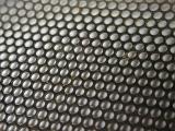 Metallic mesh background texture and pattern with repetitive rows of round holes viewed at an angle over white