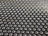 Close up on circular mesh over gray background for concepts about technology or rigid structures