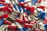 Close up background of blue and red car connectors piled into one large bunch as sun pour down onto them