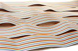 Background of colorful striped ribbon cables laying side by side on a white table