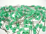 Scattered pile of new green colored light emitting diodes over isolated white background