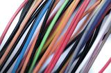 Colorful collection of low voltage wires covered in orange, red, green, blue , brown, white and black plastic in a close up diagonal view