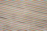 Horizontal angled strands of computer wire ribbon colored in red, yellow, blue, green, purple, white and black