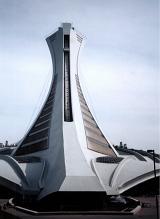 Montreal Olympic stadium tower viewed from the back from low angle against grey sky. Quebec, Canada