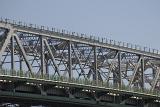 Detail showing the span of a truss bridge against a clear sky in an architectural or structural engineering concept