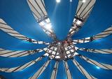 Looking into the apex of the Big Top marquis at a circus with blue canvas and visible framework with spotlights