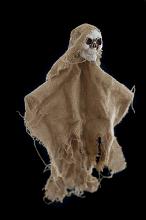 Rustic Halloween skull decoration wrapped in tattered burlap over a black background