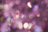 an abstract and diffuse sparkle effect background with a predominantly pink and purple colour