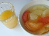 Healthy breakfast of a plate of assorted citrus fruit segments and a glass of fresh orange juice, view from above