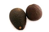 Two whole fresh ripe avocado pears, Persea americana, with one viewed on its side and the other from the top over white