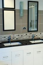 a modern tiled bathroom with twin hand basins