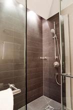 tiled modern shower cubicle with glass door