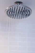 a large metal shower head with running water