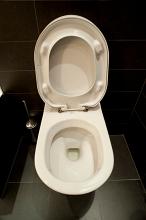 head on view of a toilet with seat up