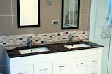 a modern bathroom with dual sinks in a stone topped sink unit