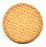 Closeup view of the texture of a commercial plain digestive wholegrain biscuit eaten as an accompaniment to cheese and other savory food