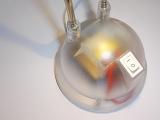 Close Up of Transparent Lamp Base with Visible Electrical Components and Switch in On Position