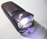 Close Up of Illuminated Purple Flashlight Torch with Lit Lamp on White Background