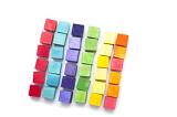Colorful still life of wooden toy building blocks or cubes arranged in a square in neat color differentiated rows on a white background