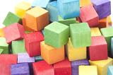 Abstract Background - Close Up of Colorful Wooden Blocks Piled in Studio with White Background - Childhood Toy Concept Image