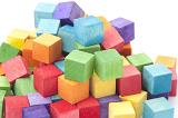 Jumbled Pile of Multi-Colored Wooden Cube Blocks Stacked in Studio with White Background and Copy Space - Childhood Concept Image
