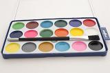 New open watercolor paint box and paint brush for kids with colorful paints in rows in circular pots