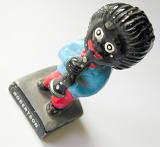 Vintage Robertson musician figure of a black Gollywog playing a clarinet, now considered a racist icon, viewed high angle over white