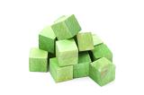 Pile of educational green wooden cubes or building blocks for young children to play with over a white background