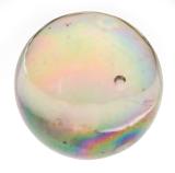 Iridescent clear glass marble with a bubble refracting the light to show a colorful spectrum isolated on white