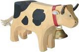 Rustic hand carved wooden cow with a bell around its neck and black markings isolated on white