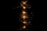 a vertical line of warm coloured sparks of light depicting the number 1