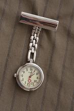 Nurses silver metal fob watch on a chain with a clip for fastening it to her uniform