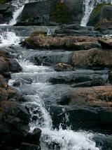 Mountain stream flowing over rocks providing fresh clean water, an important natural resource