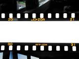 A close up of two negative film strips on a white background with copy space.