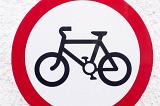 No Bicycles forbidding road sign with black image of a bicycle on white background inside the red circle, viewed cropped in close-up