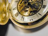 close up on the hands and mechanism of a swiss made pocket watch