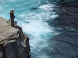 a fisherman stood on a clifftop
