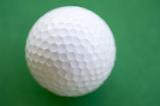 a white golf ball on a green background