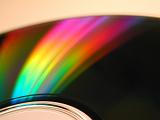Spectrum rainbow light reflection on CD or DVD optical disc radial surface, as digital object beauty background concept
