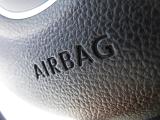 Airbag sign punched into the black vinyl or leather on a car dashboard in a close up macro view