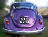 Rear view of clean and well maintained purple car with motion effect around it outside