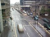 Traffic travelling through town on a main thoroughfare on a rainy day with motion blur, high angle view