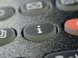 Black information button on a mobile phone or telephone keypad in a close up view in a technology concept