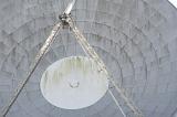 Close up detail of an old satellite dish or parabolic antenna at a ground station in a telecommunications concept