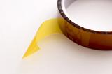 Closeup of roll of Kapton polyimide tape in spool with loose end
